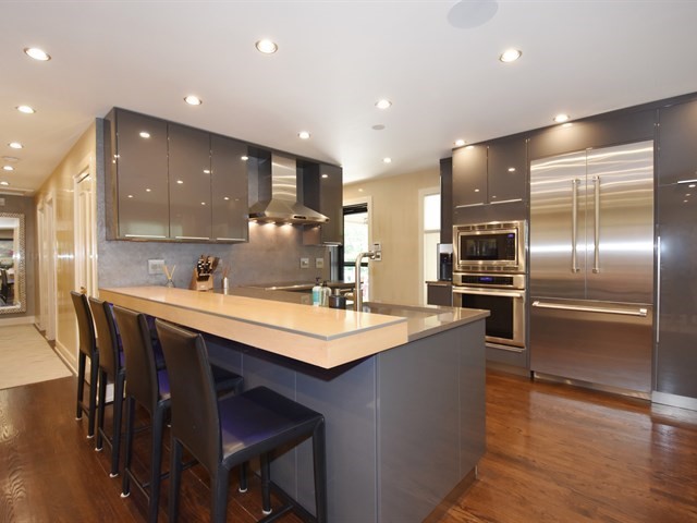 7715 East Prairie Road Skokie, IL 60076 - Photo 8 of 26 a kitchen with kitchen island a sink stove and refrigerator