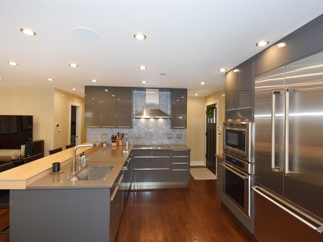 7715 East Prairie Road Skokie, IL 60076 - Photo 9 of 26 a kitchen with stainless steel appliances a refrigerator and a sink