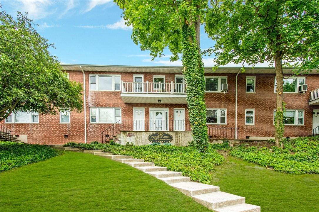 184 Purchase Street, Unit 15 Rye, NY 10580 - Photo 1 of 1 front view of a house with a yard