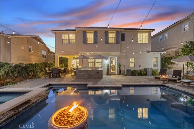 a view of a swimming pool with outdoor seating