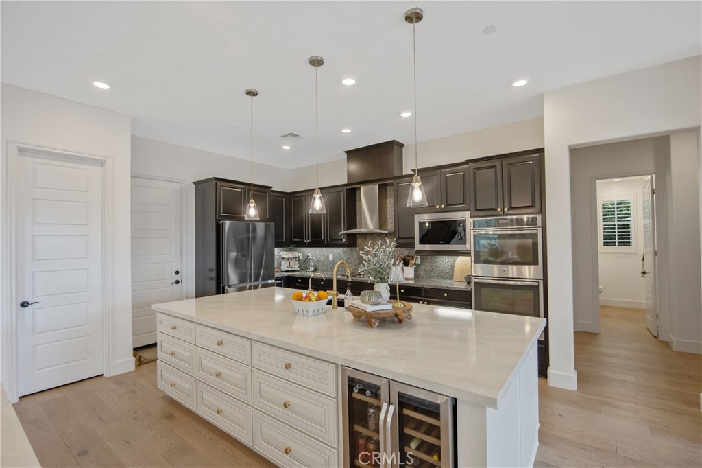 26464 Township Street Saugus, CA 91350 - Photo 11 of 74 a kitchen with kitchen island a sink stainless steel appliances and cabinets
