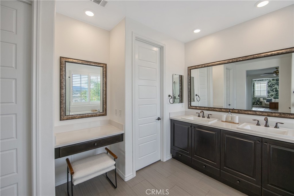 26464 Township Street Saugus, CA 91350 - Photo 35 of 74 a bathroom with a double vanity sink and mirror