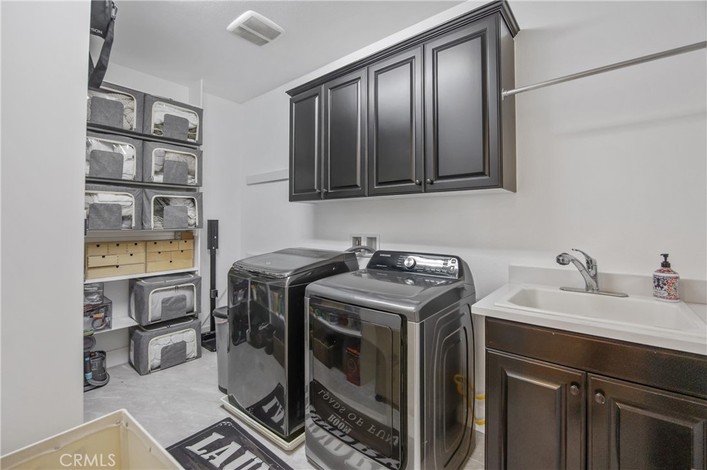 26464 Township Street Saugus, CA 91350 - Photo 37 of 74 a utility room with sink dryer and washer