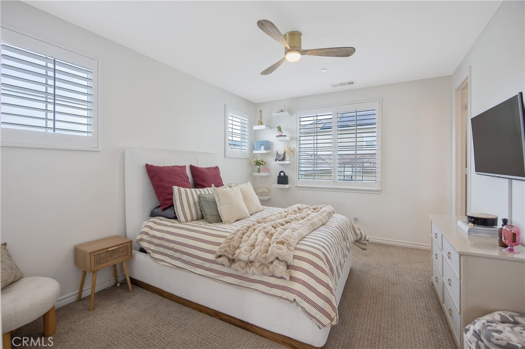 26464 Township Street Saugus, CA 91350 - Photo 41 of 74 a bedroom with a bed a couch and a flat screen tv