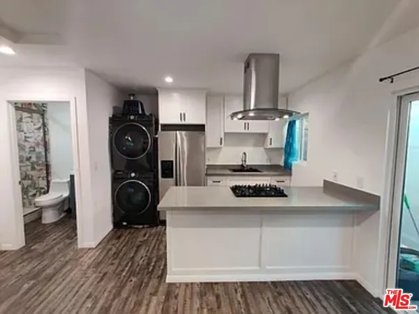 a kitchen with a stove and white cabinets