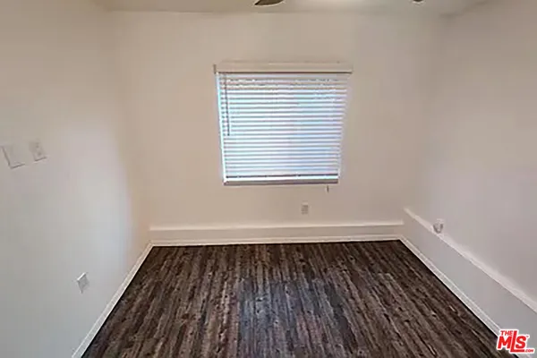 a view of a room with wooden floor and a window