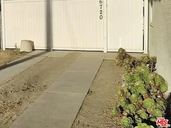 a view of a backyard of the house