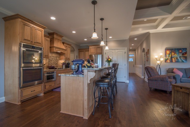 2488 Double Log Cabin Road Lebanon, TN 37087 - Photo 13 of 50 a kitchen with a dining table wooden floor stainless steel appliances and cabinets