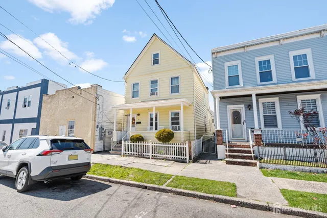 a couple of cars parked in front of a house