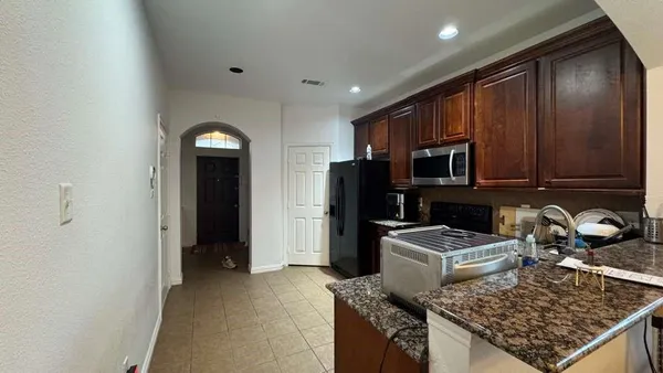 a kitchen with sink refrigerator and stove