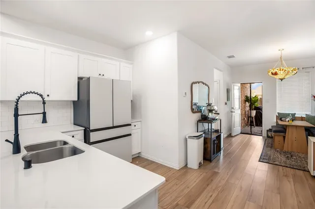 a kitchen with granite countertop a refrigerator and a sink