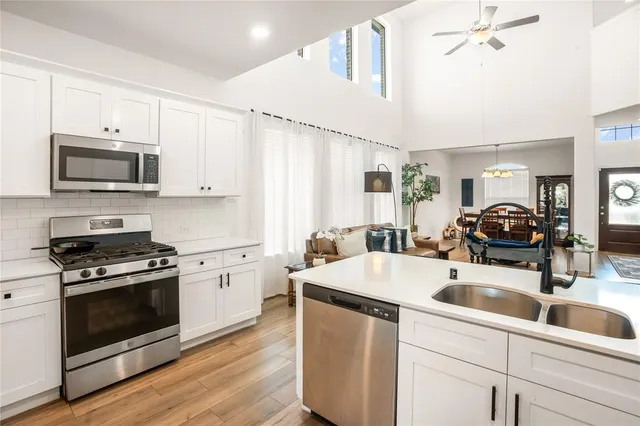 a kitchen with a sink stove and microwave