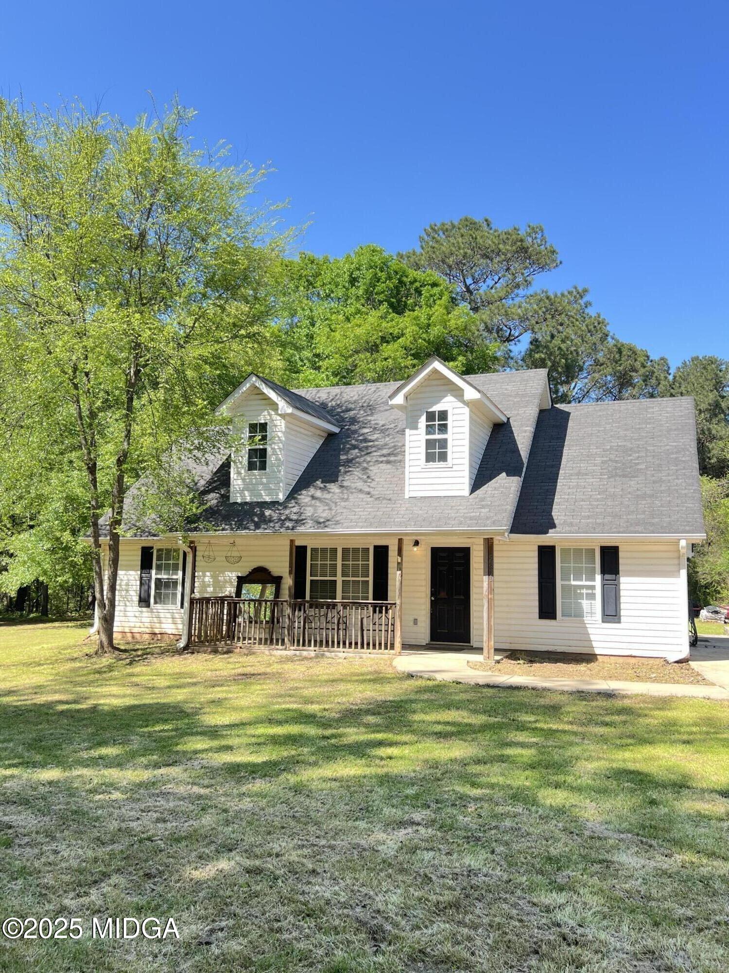 231 Red Berry Road Jackson, GA 30233 - Photo 1 of 23 a front view of a house with a garden