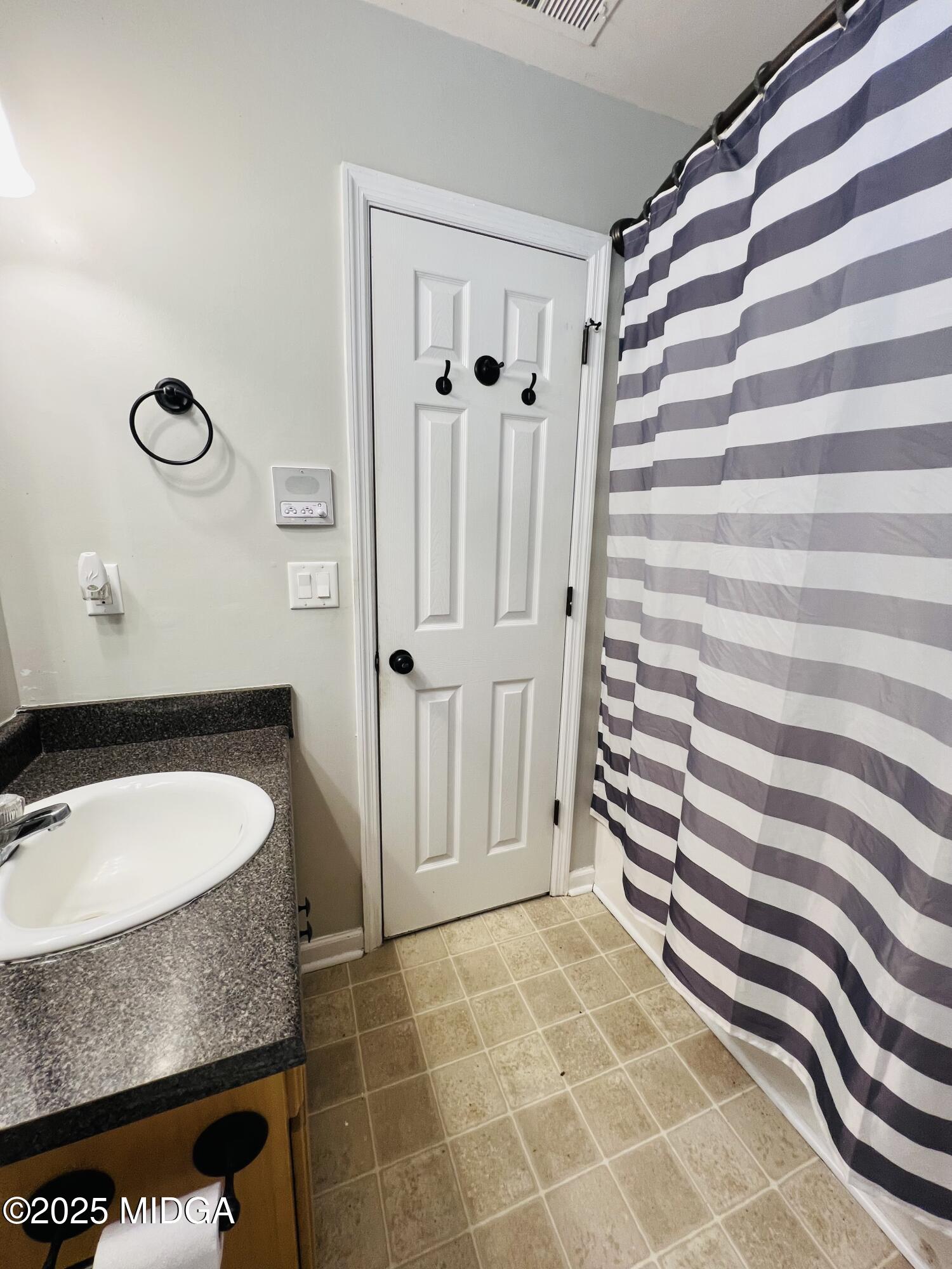 231 Red Berry Road Jackson, GA 30233 - Photo 13 of 23 a bathroom with a granite countertop sink and a mirror