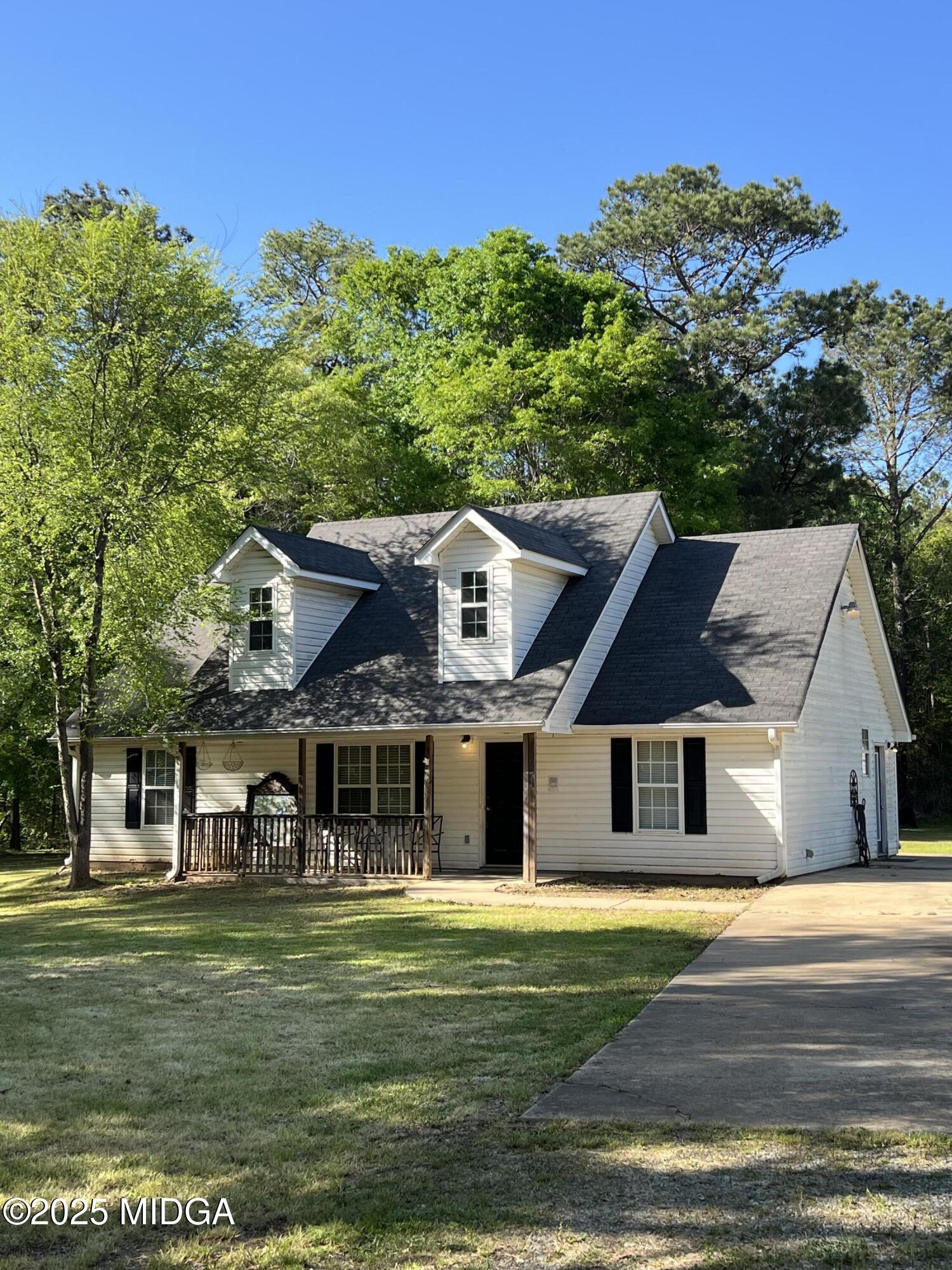 231 Red Berry Road Jackson, GA 30233 - Photo 3 of 23 a front view of a house with a garden