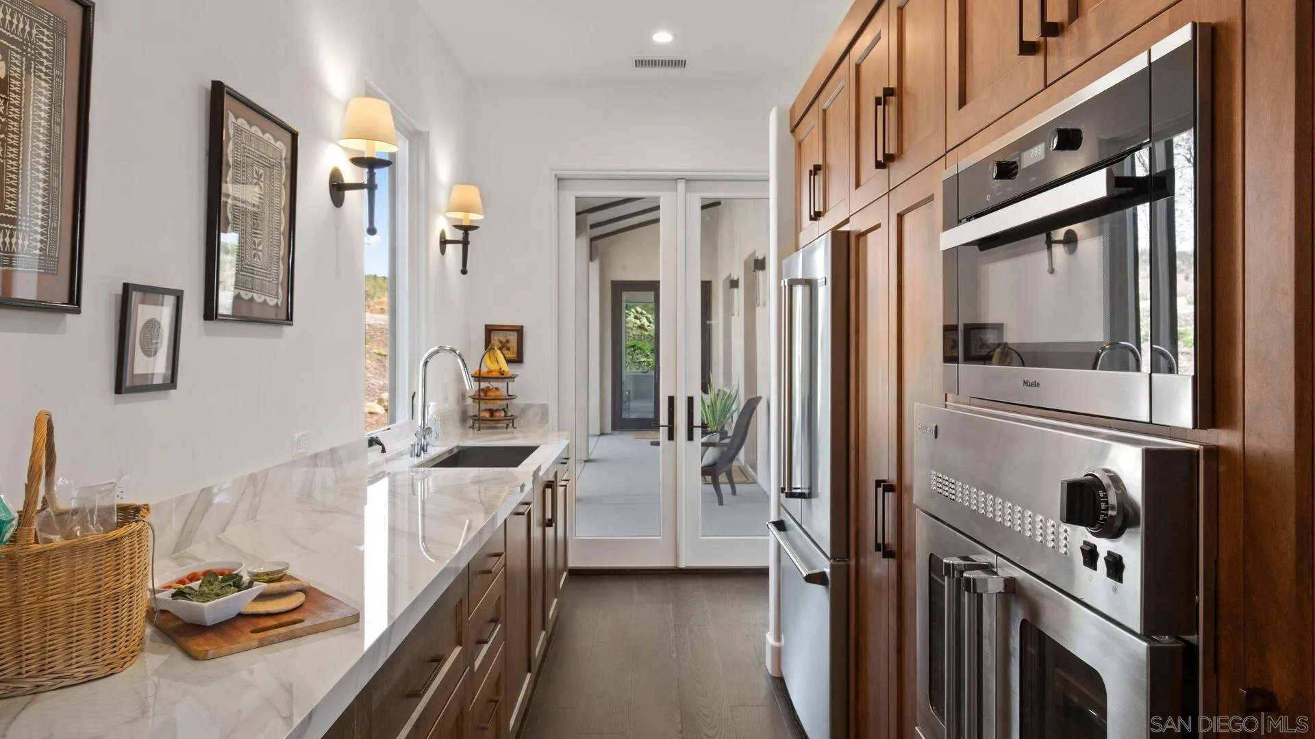 16674 Liberty Ridge San Diego, CA 92127 - Photo 14 of 35 a kitchen with sink refrigerator and stove