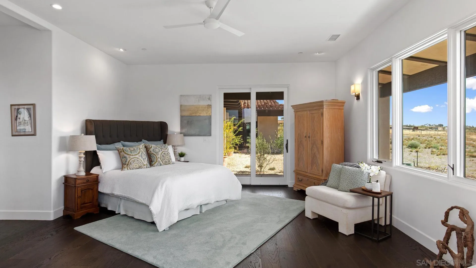 16674 Liberty Ridge San Diego, CA 92127 - Photo 16 of 35 a bedroom with a bed couch and a large window