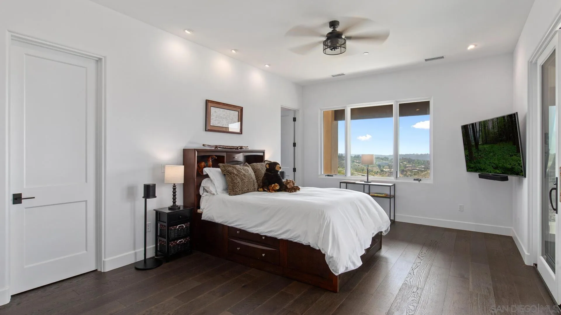 16674 Liberty Ridge San Diego, CA 92127 - Photo 22 of 35 a bedroom with a bed and a flat tv screen on dresser