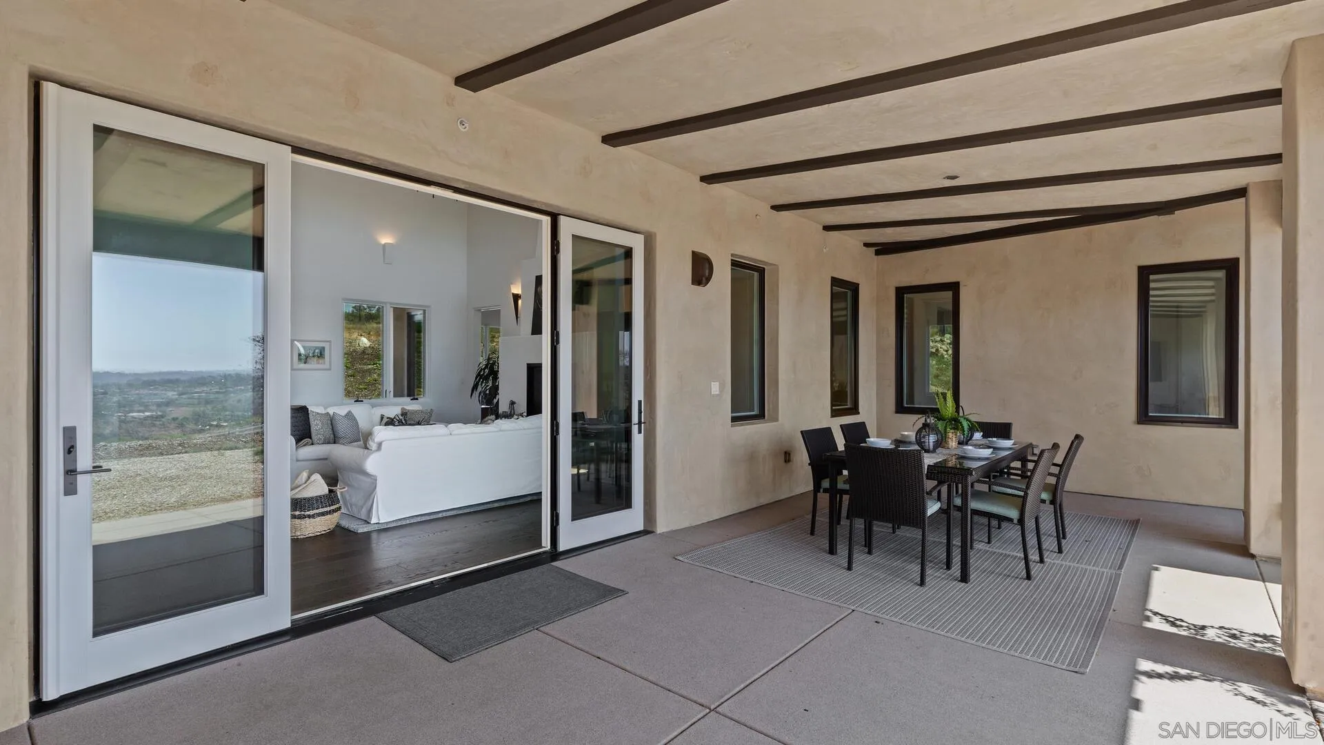 16674 Liberty Ridge San Diego, CA 92127 - Photo 27 of 35 a view of a hallway with dining area and chandelier