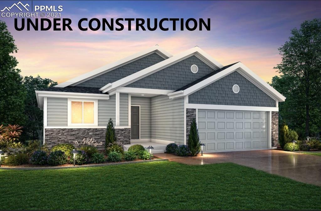 10541 Summer Ridge Drive Peyton, CO 80831 - Photo 1 of 6 a front view of a house with a garden and garage