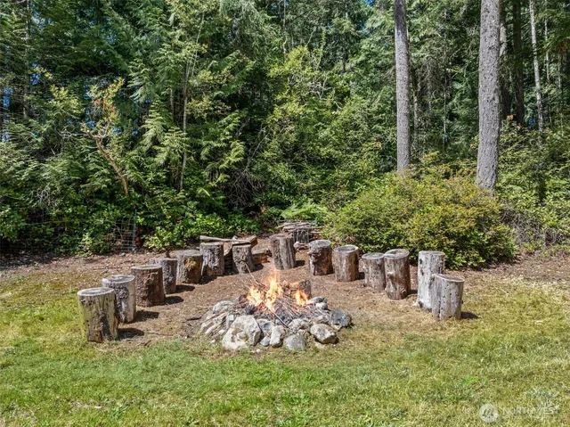 a view of a chair and table in backyard