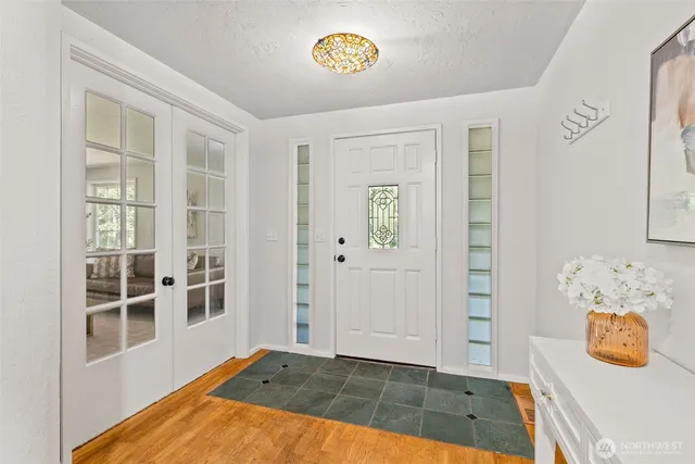 a view of a bedroom with wooden floor and a window