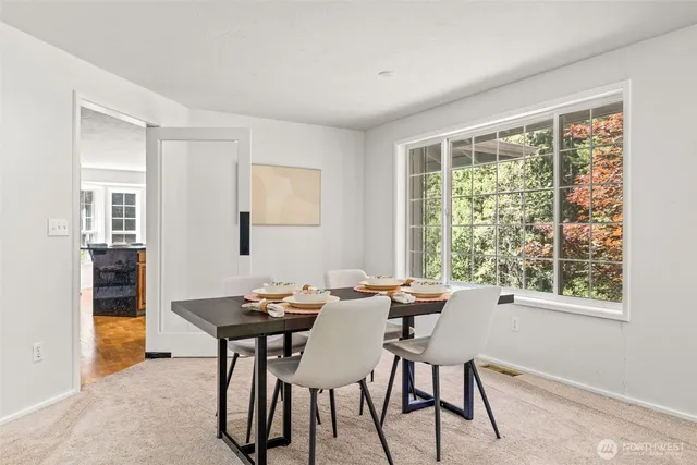 a view of a dining room with furniture and a window