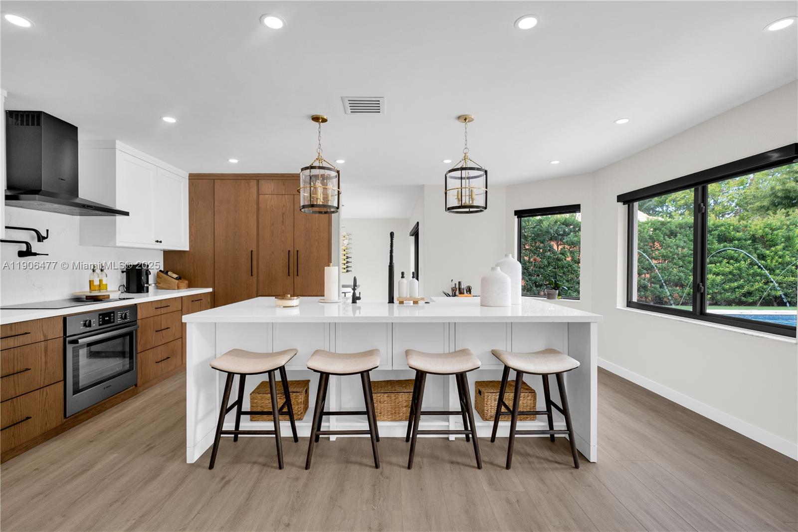 19913 Southwest 3rd Place Pembroke Pines, FL 33029 - Photo 20 of 56 a kitchen with stainless steel appliances a dining table chairs sink and wooden floor