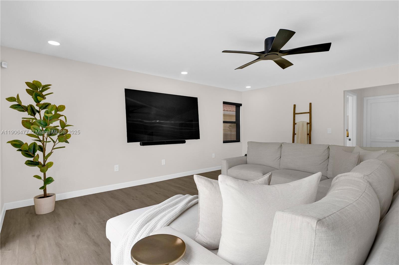 19913 Southwest 3rd Place Pembroke Pines, FL 33029 - Photo 27 of 56 a living room with furniture and a flat screen tv