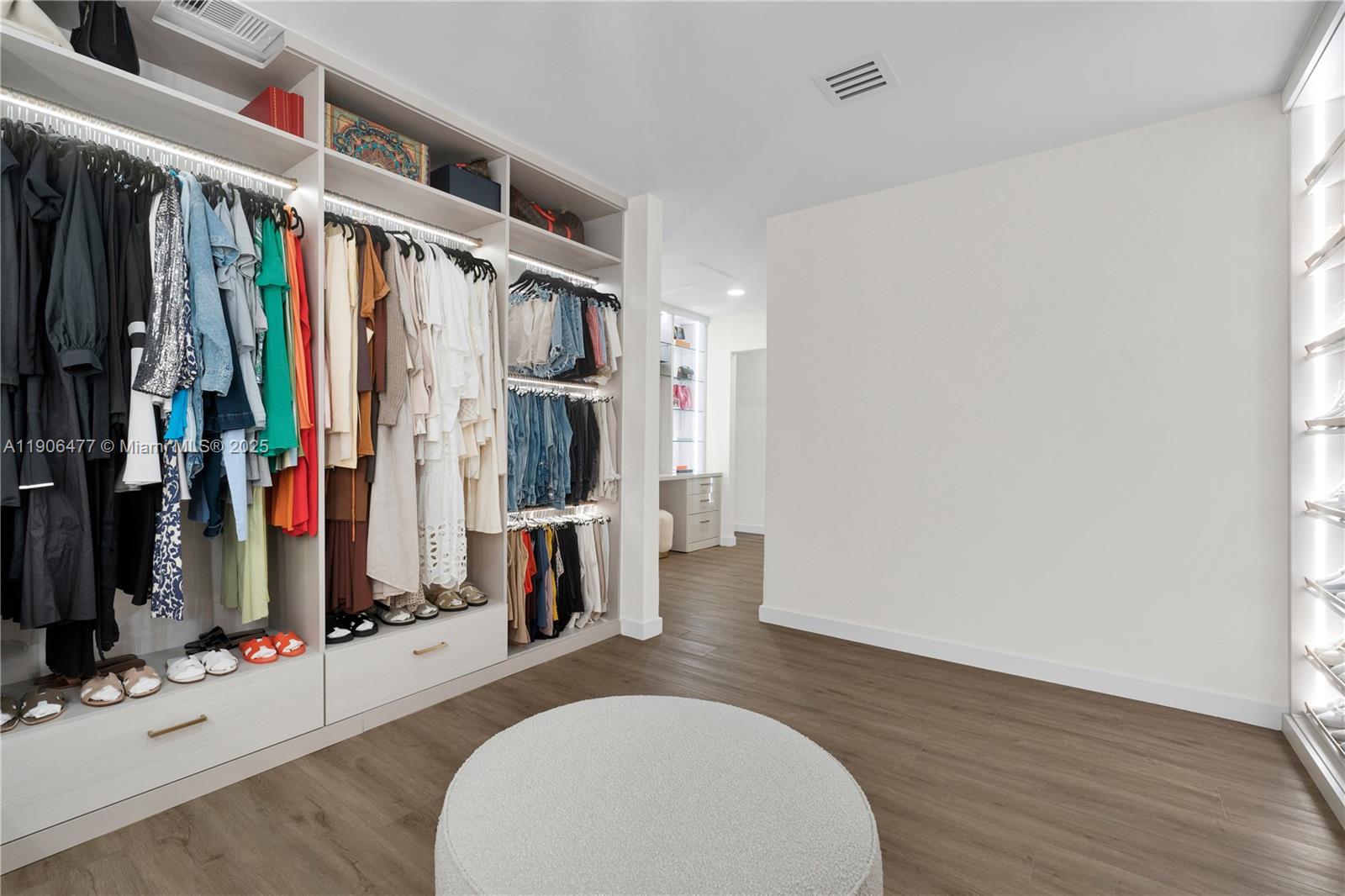 19913 Southwest 3rd Place Pembroke Pines, FL 33029 - Photo 37 of 56 a view of walk in closet with clothes and shoes