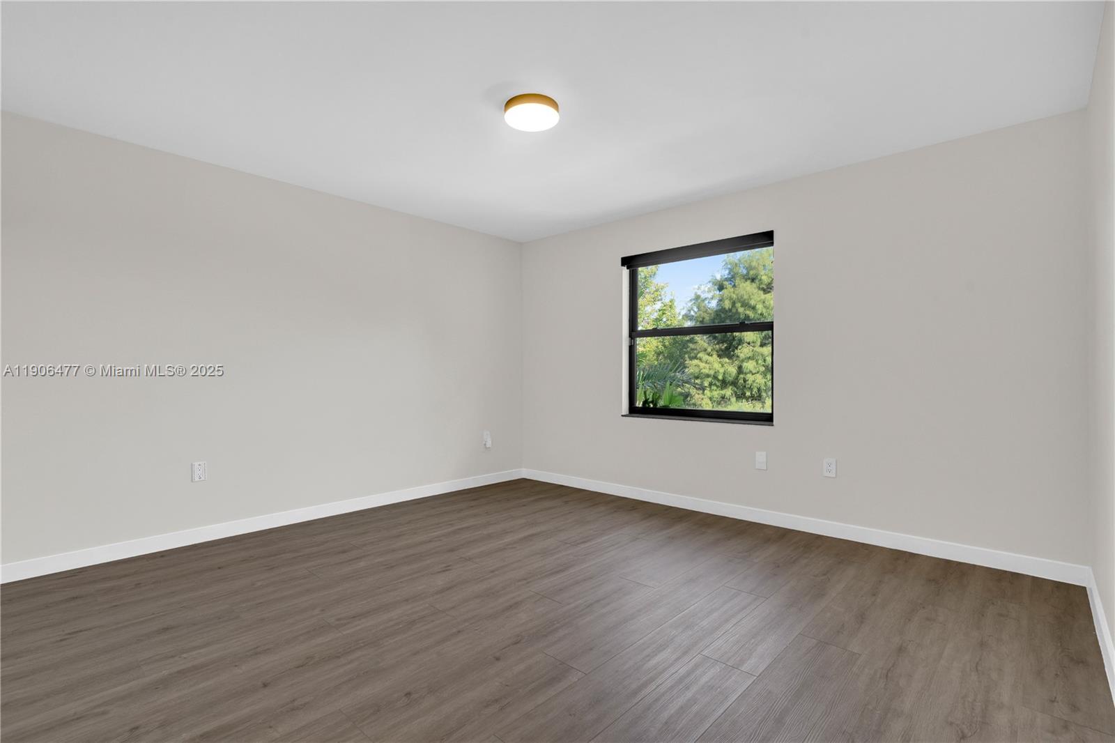 19913 Southwest 3rd Place Pembroke Pines, FL 33029 - Photo 45 of 56 an empty room with wooden floor and windows