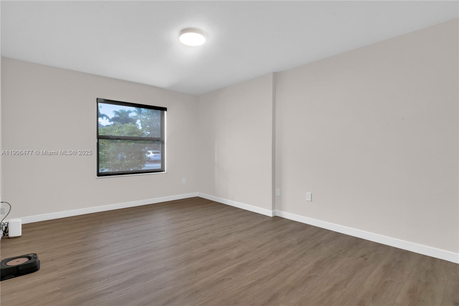 19913 Southwest 3rd Place Pembroke Pines, FL 33029 - Photo 46 of 56 an empty room with wooden floor and windows