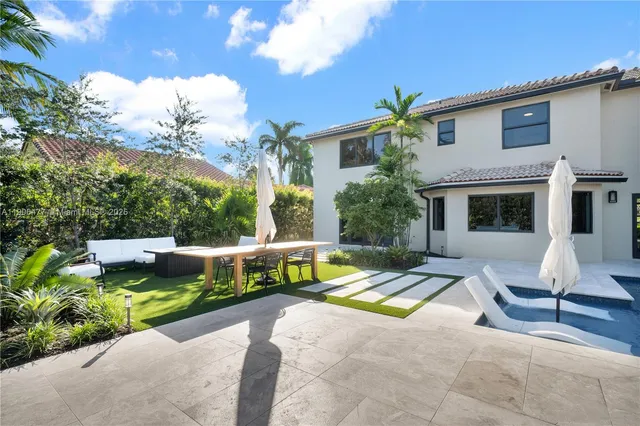 a view of a patio with table and chairs and potted plants