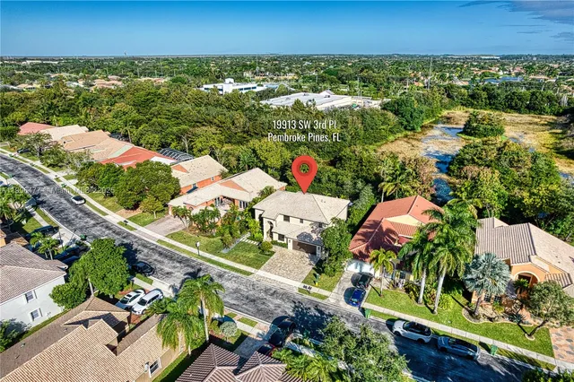 an aerial view of residential houses with outdoor space