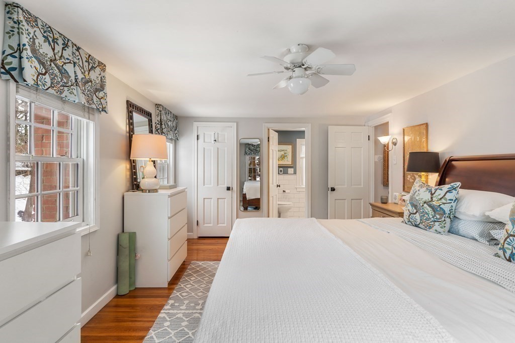 91 Valley Road Milton, MA 02186 - Photo 17 of 29 a bedroom with a large bed and a chandelier