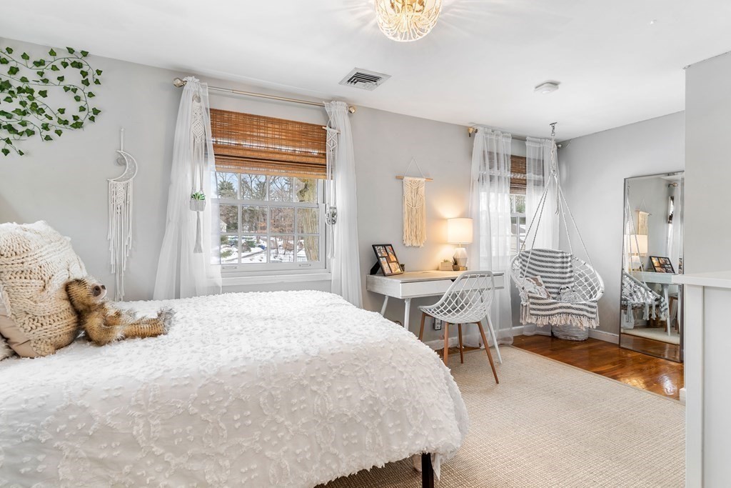 91 Valley Road Milton, MA 02186 - Photo 20 of 29 a bedroom with a bed and wooden floor