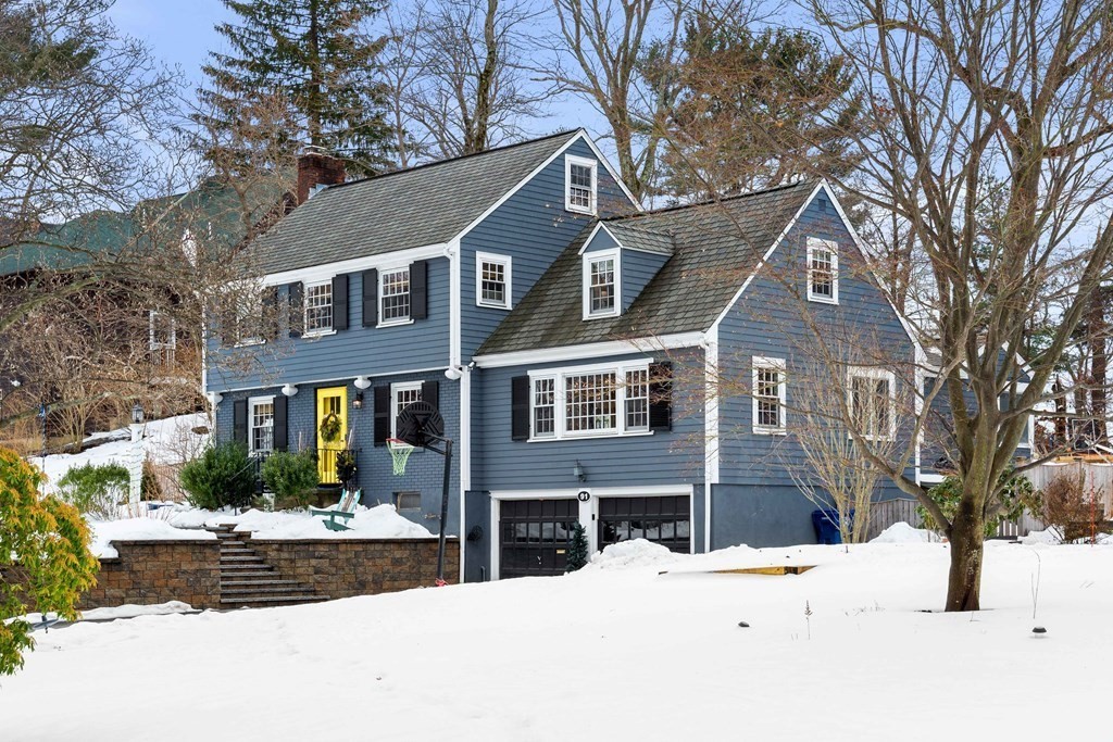 91 Valley Road Milton, MA 02186 - Photo 2 of 29 a front view of a house with a yard covered in snow