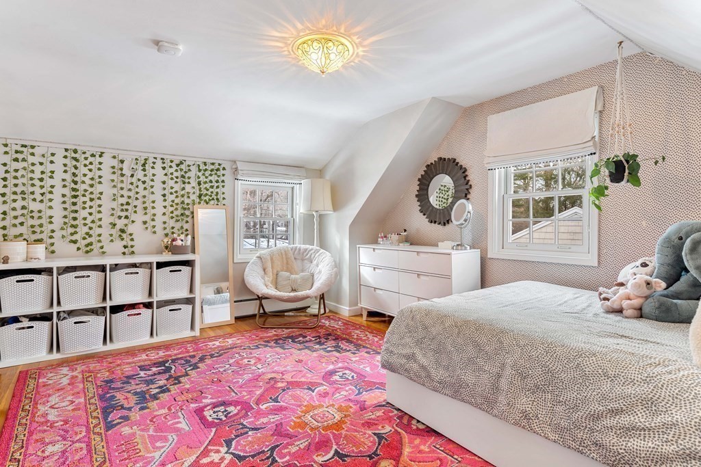 91 Valley Road Milton, MA 02186 - Photo 23 of 29 a bedroom with a bed and dresser with mirror