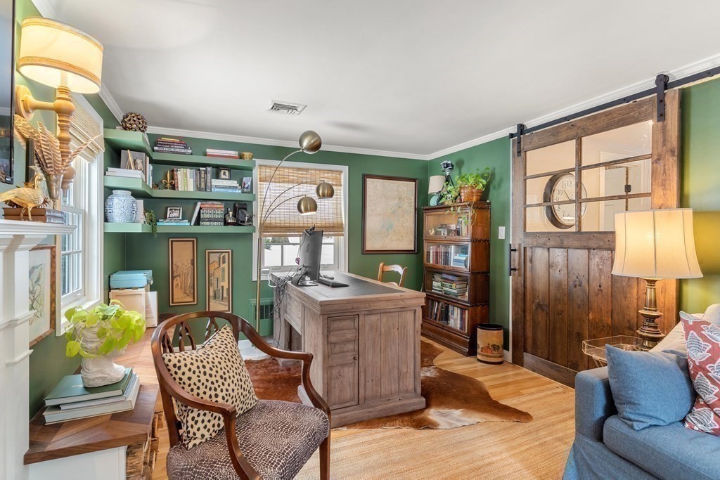 91 Valley Road Milton, MA 02186 - Photo 5 of 29 a living room with furniture a bookshelf and a large window