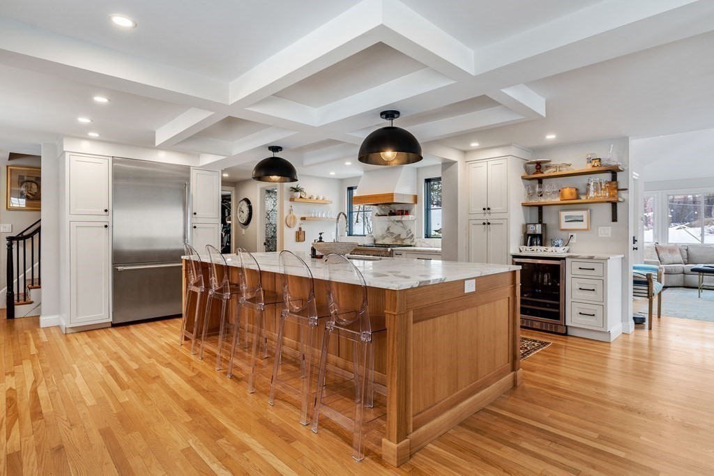 91 Valley Road Milton, MA 02186 - Photo 10 of 29 a kitchen with stainless steel appliances kitchen island granite countertop a sink a stove and a wooden floors