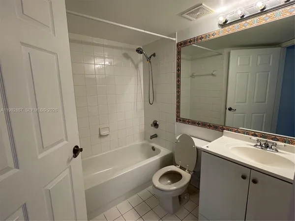 a bathroom with a tub a sink and a shower