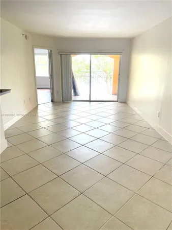a view of an empty room and a window