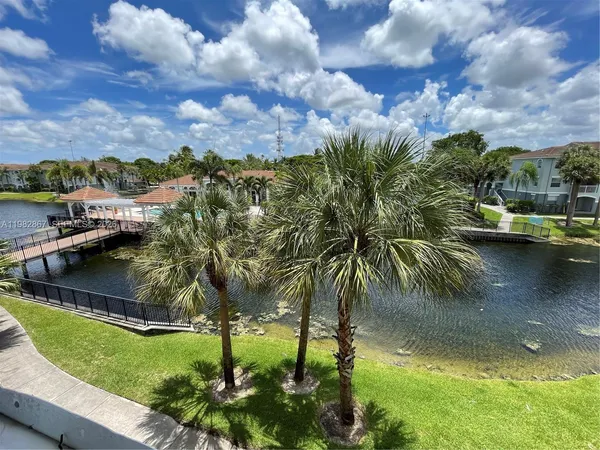 a view of a lake with houses in the back