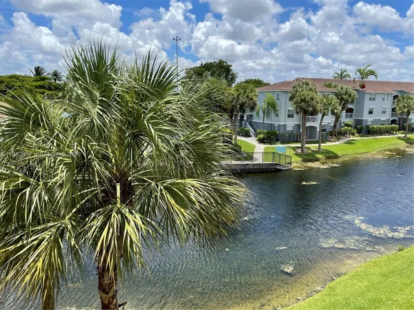 a view of yard with swimming pool and seating