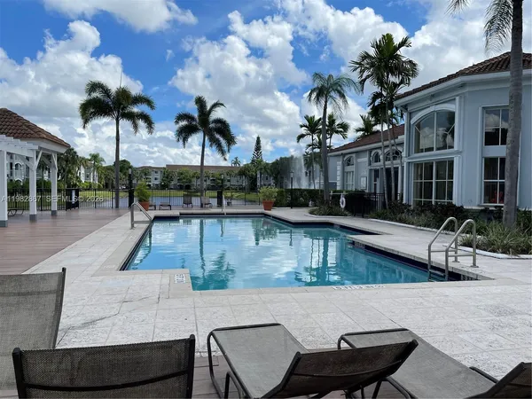 a view of a swimming pool with outdoor seating