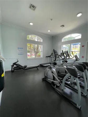 a room with gym equipment and a large window