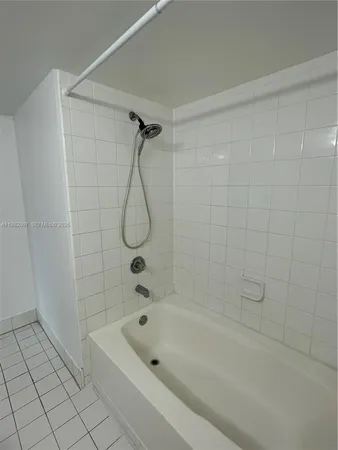 a bathroom with a bath tub with a shower