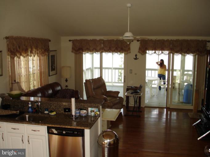 1117 Engleberth Road Essex, MD 21221 - Photo 17 of 20 a kitchen with granite countertop a stove and a view of living room