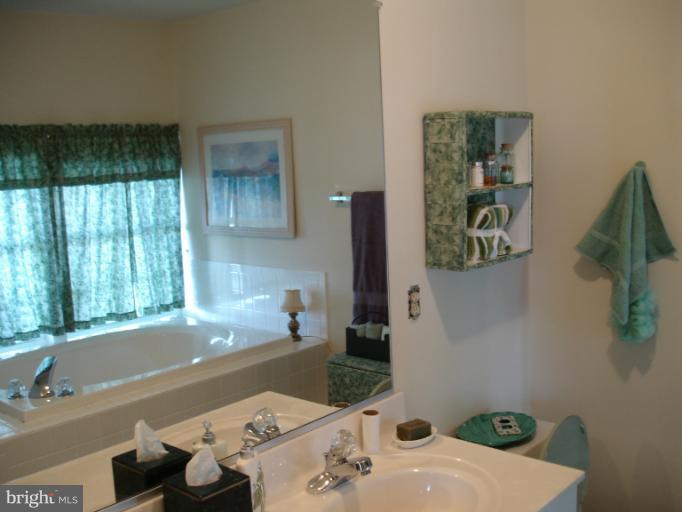 1117 Engleberth Road Essex, MD 21221 - Photo 9 of 20 a bath tub sitting in a bathroom next to a window