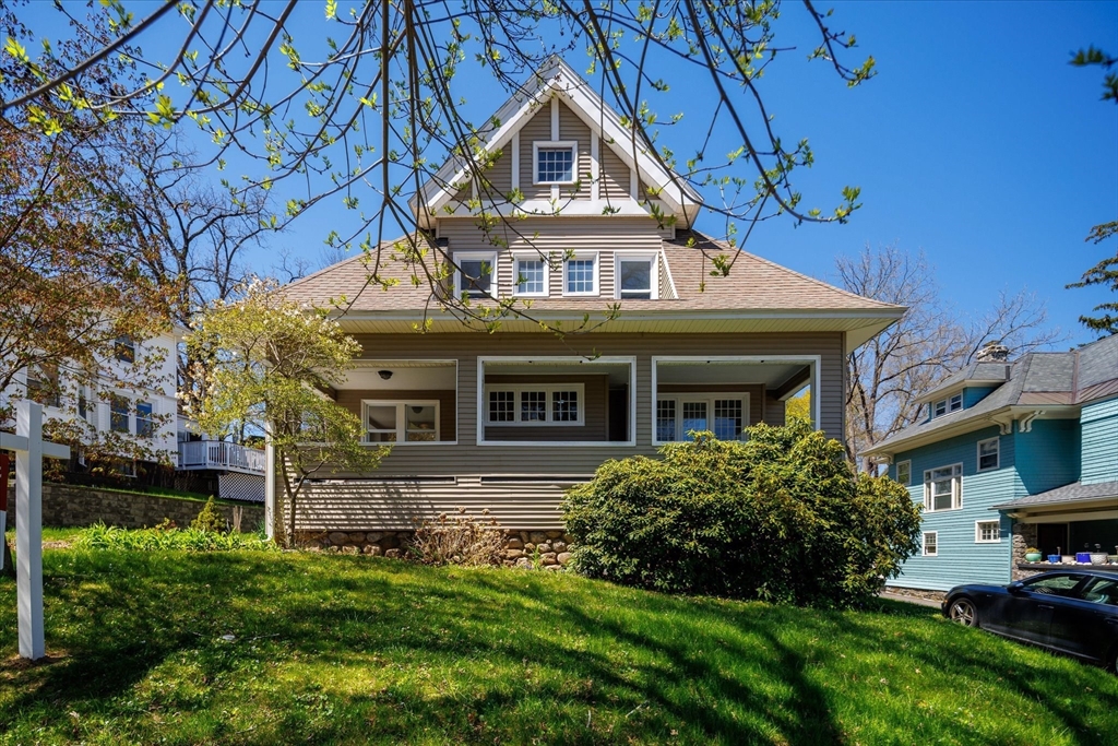 a front view of a house with a garden
